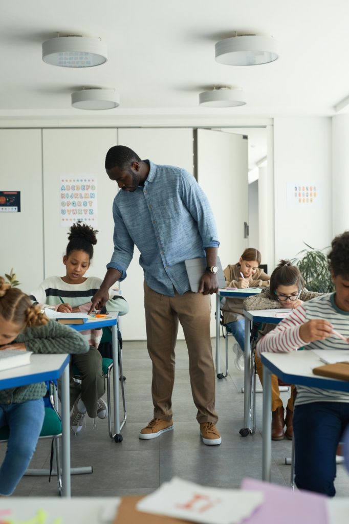 Teacher Helping Kids in Class